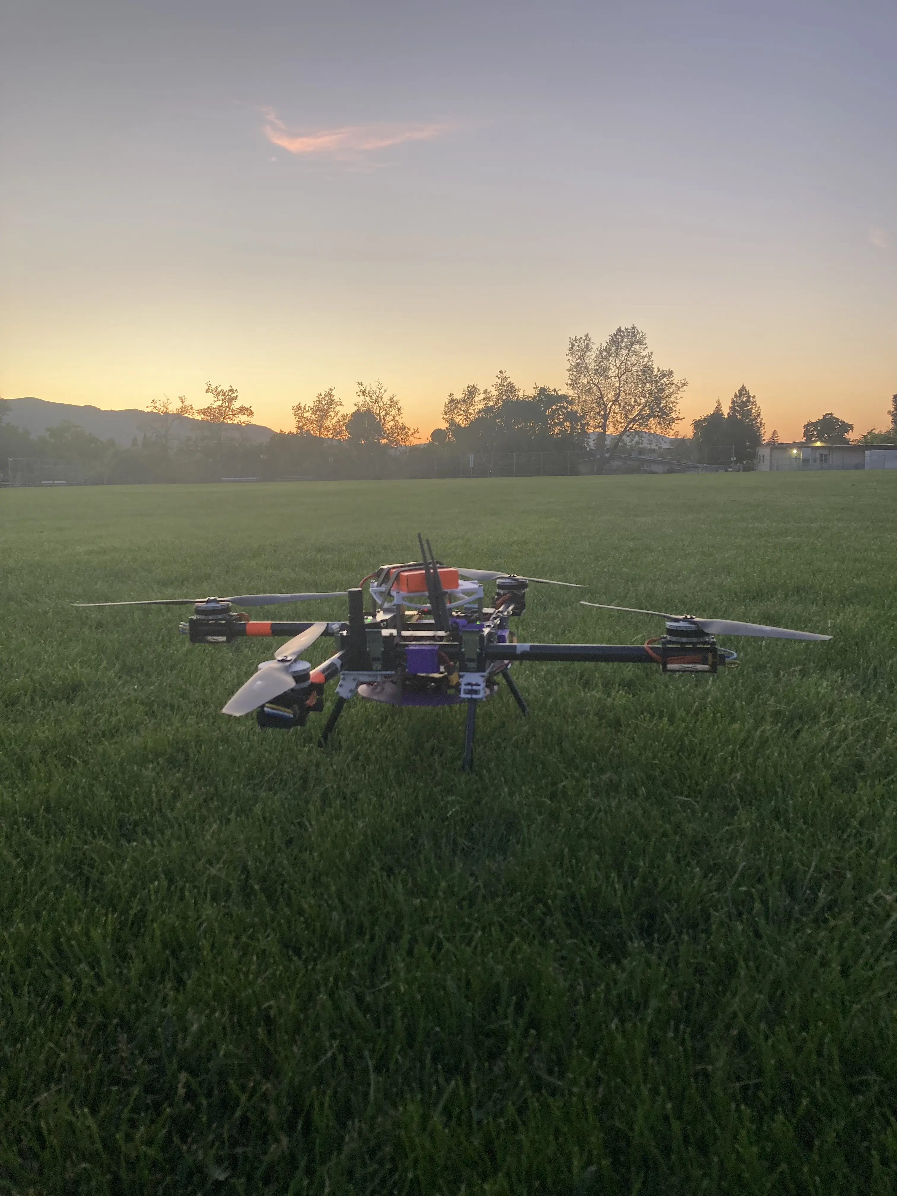 A picture of our brand new drone, Zephyrus, sitting in a field at sunset